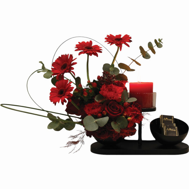 Red roses assortment with chocolate on black stand